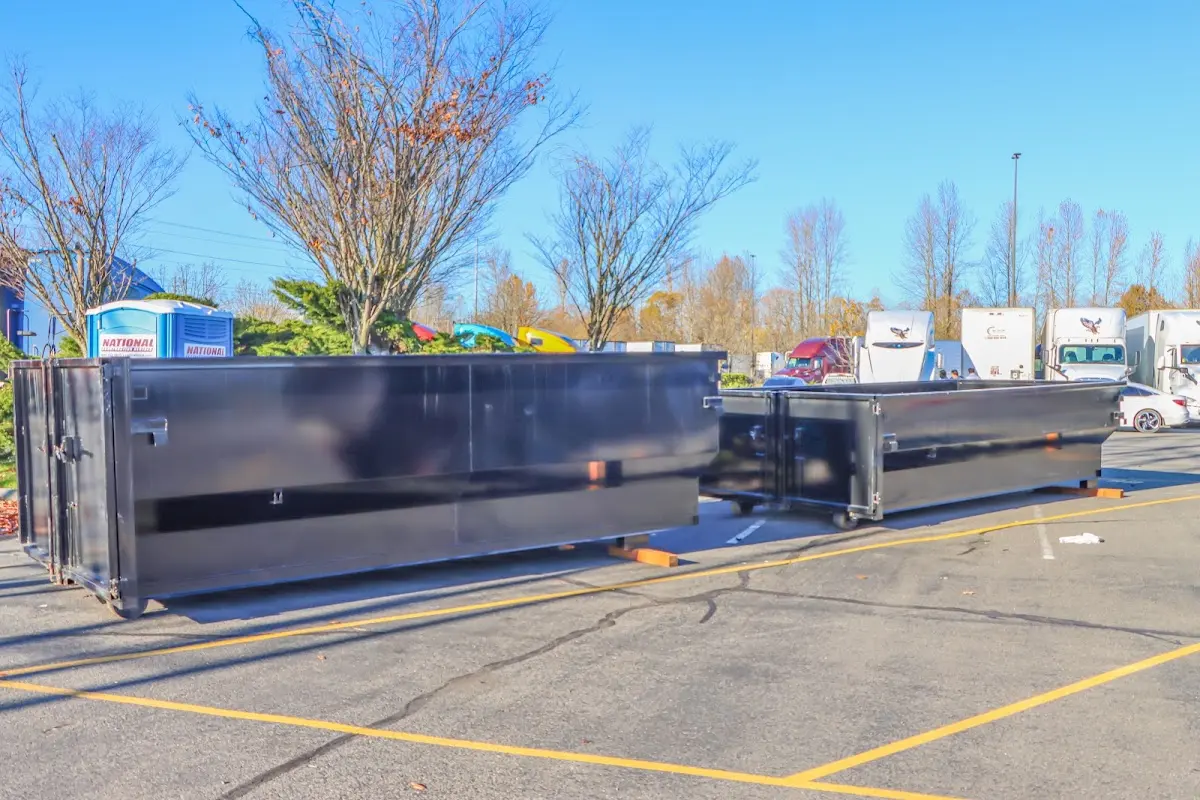 Professional dumpster rental service with roll-off container on residential driveway in Sugar Grove